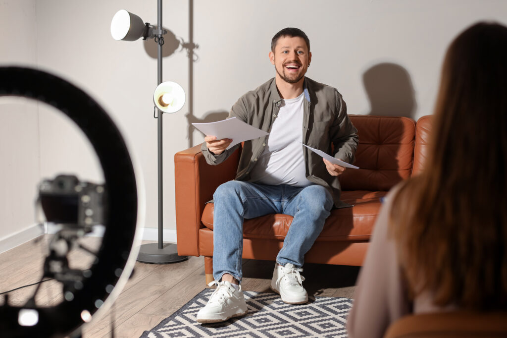 Actor reading for a casting director in an audition room with a ring light