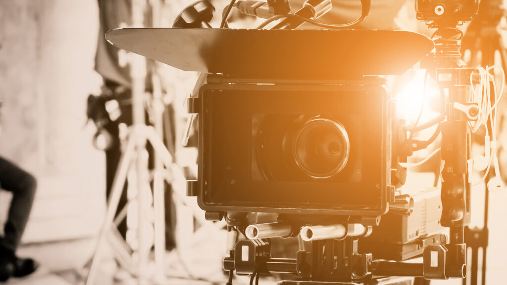 Cinema camera with warm light on a film set