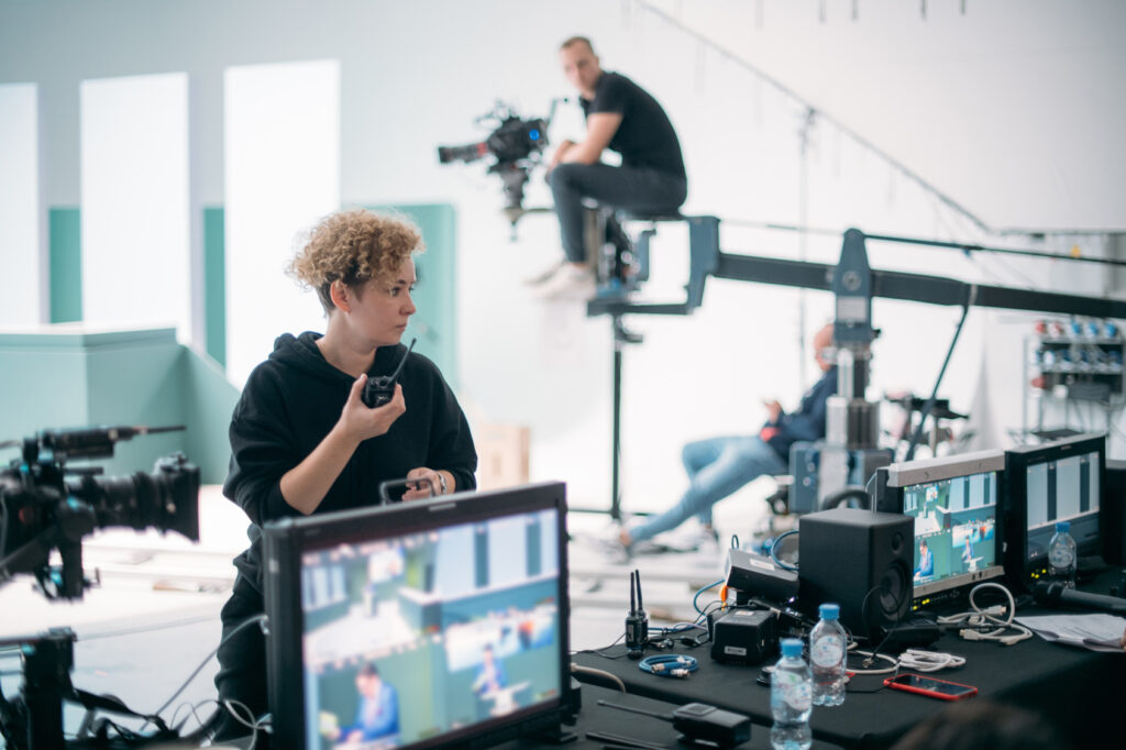 A director working with a camera crew on a film set